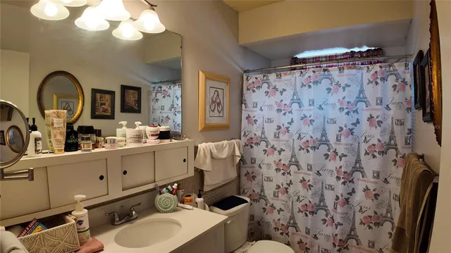 a bedroom with a bed and a painting on the wall