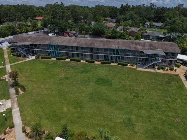an aerial view of a house with garden space and street view