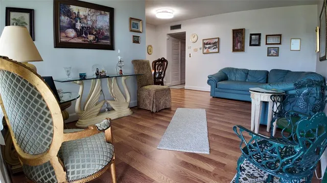 a living room with furniture and a dining table