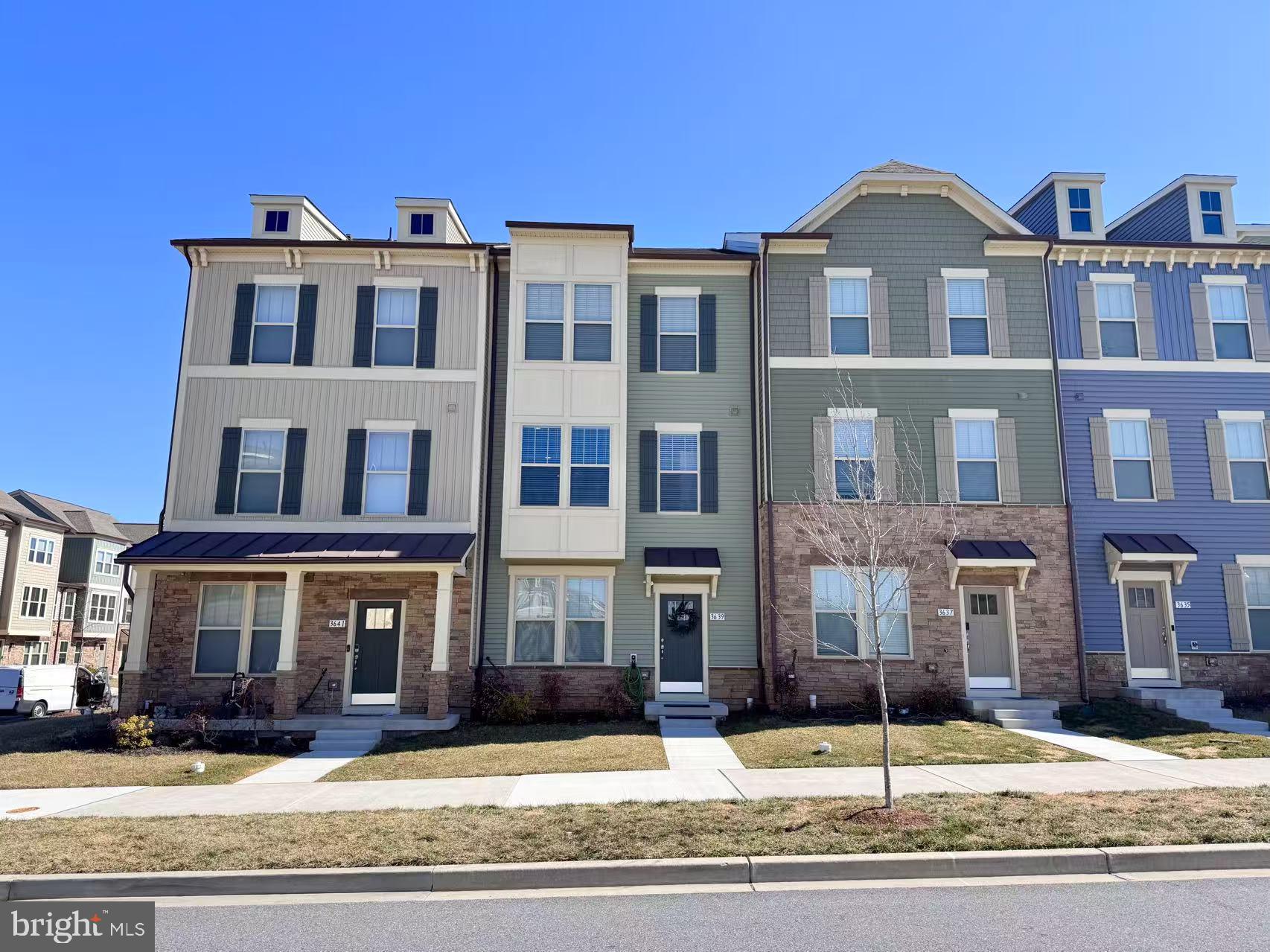 3639 Stone Barn Drive Frederick, MD 21704 - Photo 1 of 21 a front view of a brick building next to a yard