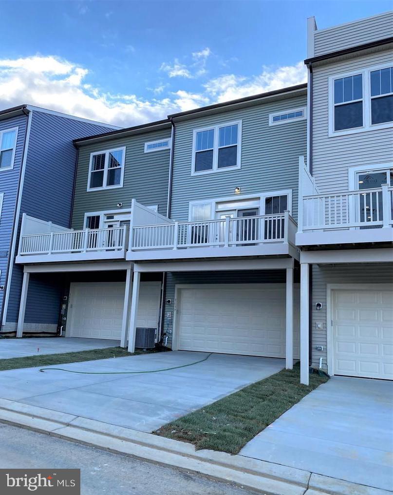 3639 Stone Barn Drive Frederick, MD 21704 - Photo 13 of 21 a view of a large building next to a yard