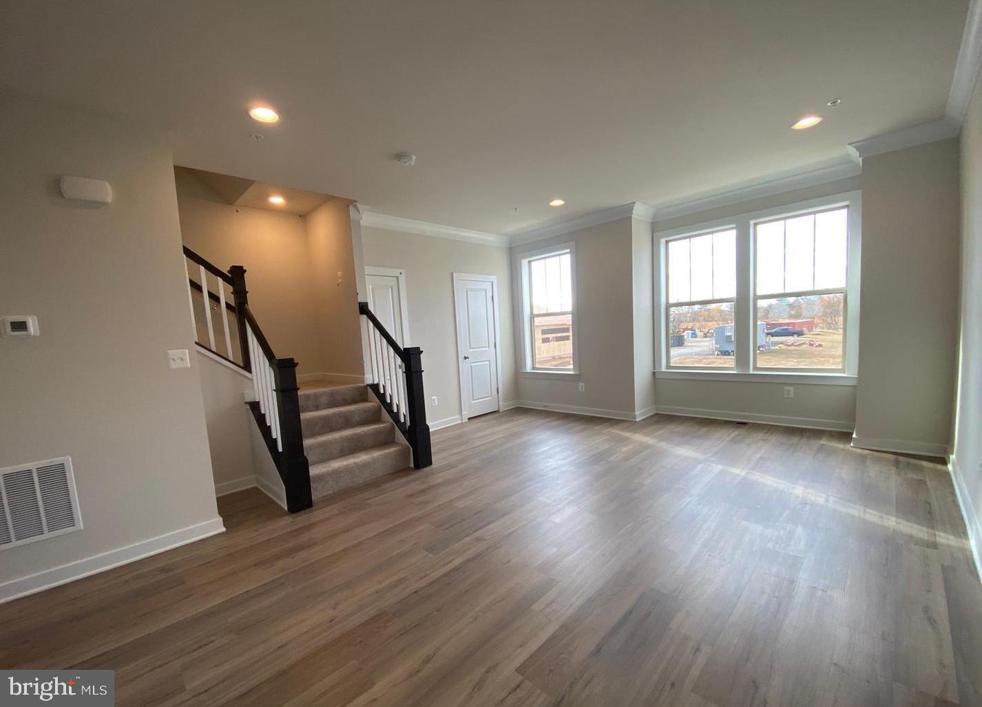 3639 Stone Barn Drive Frederick, MD 21704 - Photo 6 of 21 an empty room with wooden floor and windows