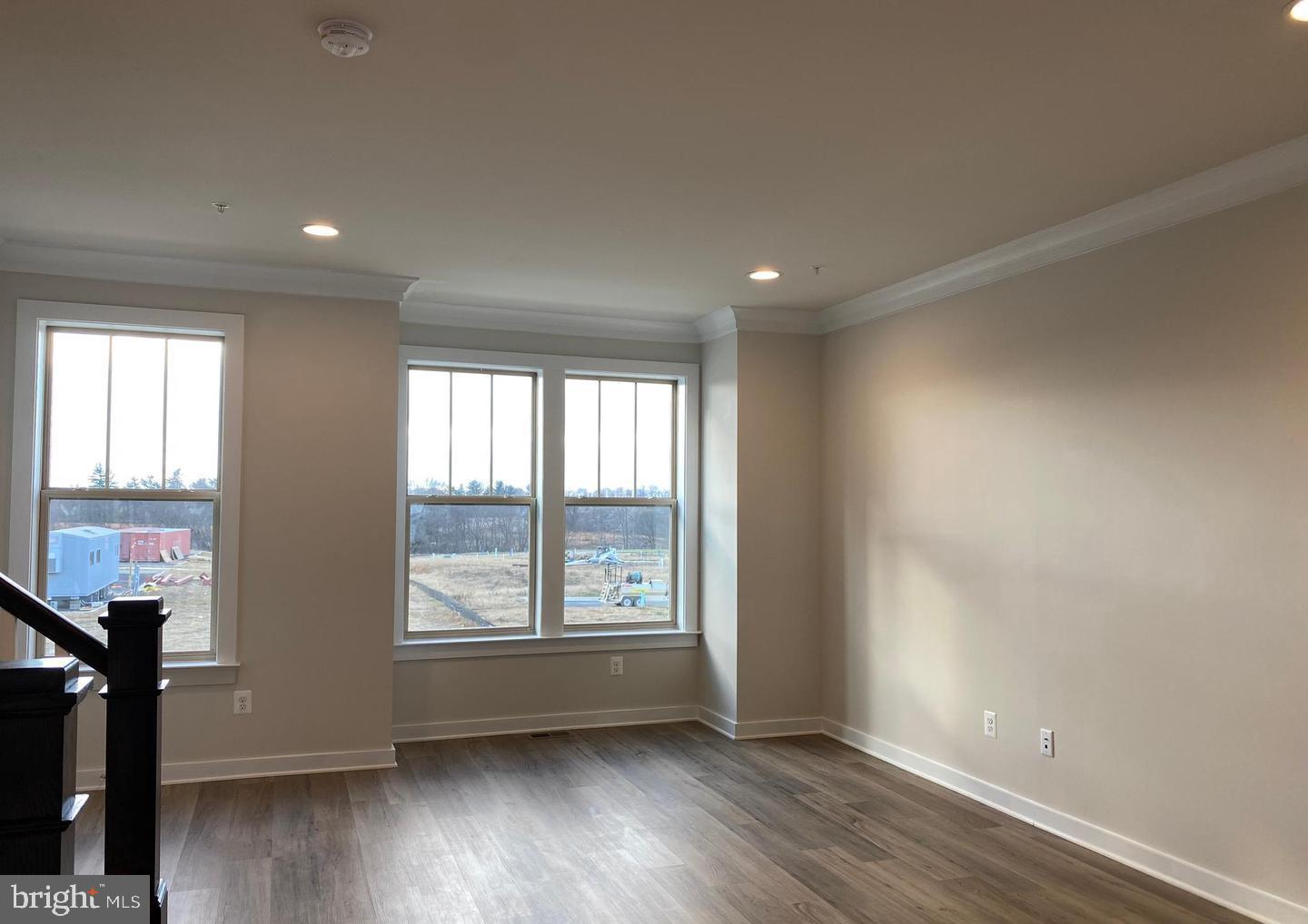 3639 Stone Barn Drive Frederick, MD 21704 - Photo 8 of 21 an empty room with wooden floor and windows