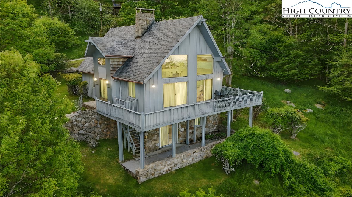 178 Buckeye Lane Seven Devils, NC 28604 - Photo 2 of 9 an aerial view of a house with a big yard and large trees