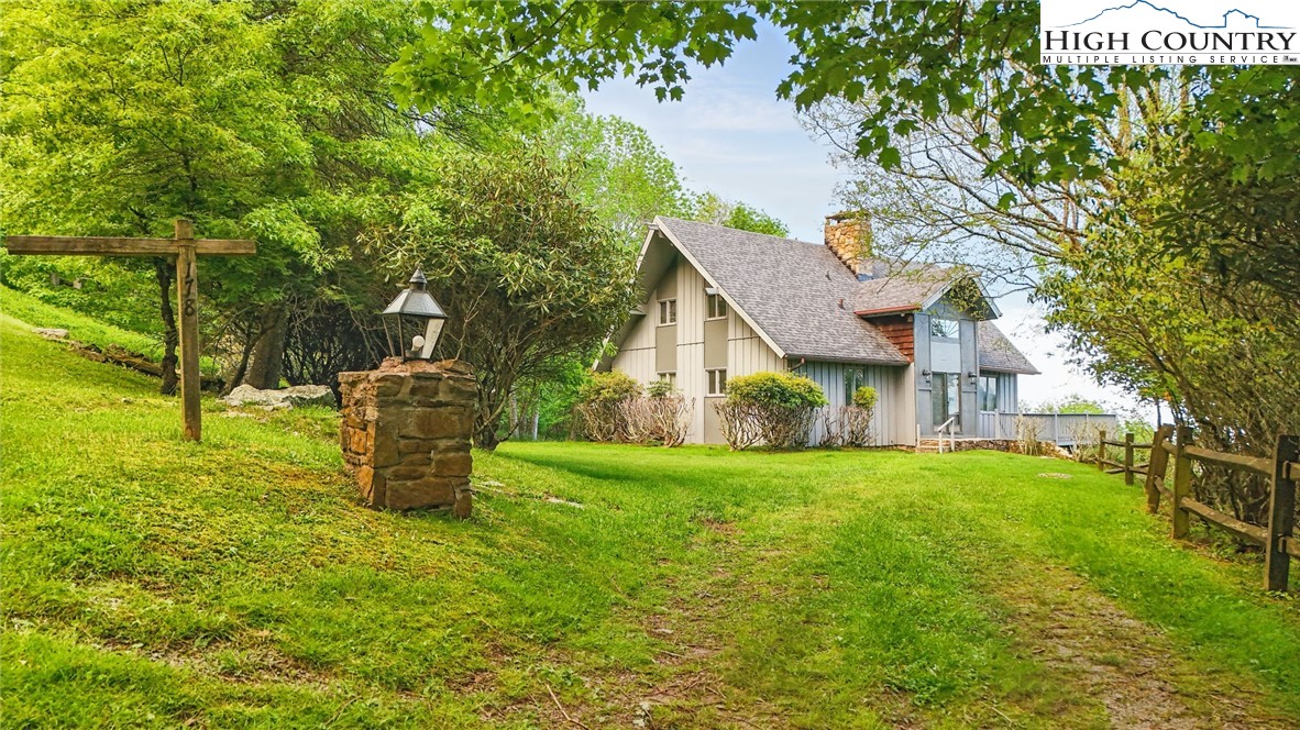 178 Buckeye Lane Seven Devils, NC 28604 - Photo 4 of 9 a view of a house with backyard and garden