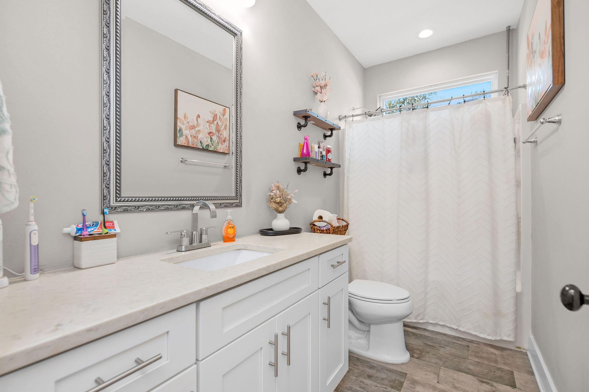 8914 Timber Lane Navarre, FL 32566 - Photo 32 of 40 a bathroom with a granite countertop sink mirror vanity and toilet