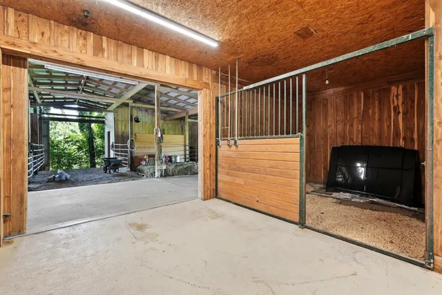 a living room with furniture a rug and a large window