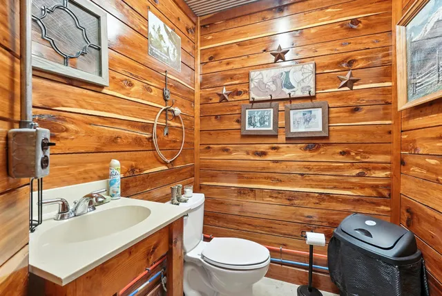 a kitchen with stainless steel appliances granite countertop a refrigerator a stove top oven and a dining table with wooden floor