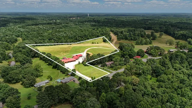 a view of a house with a backyard and a garden