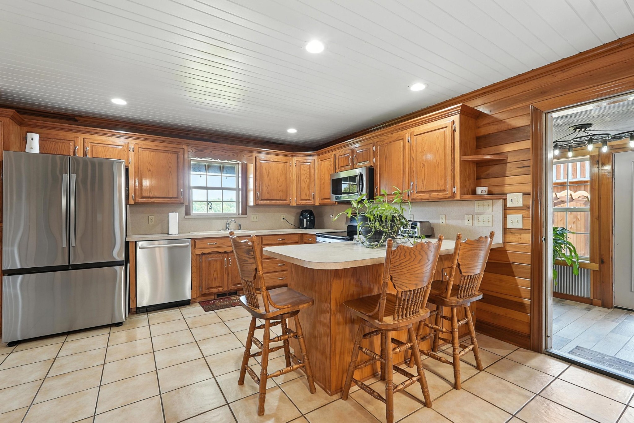 1880 Clydeton Road Waverly, TN 37185 - Photo 43 of 85 a kitchen with stainless steel appliances granite countertop a refrigerator a stove top oven and a dining table with wooden floor