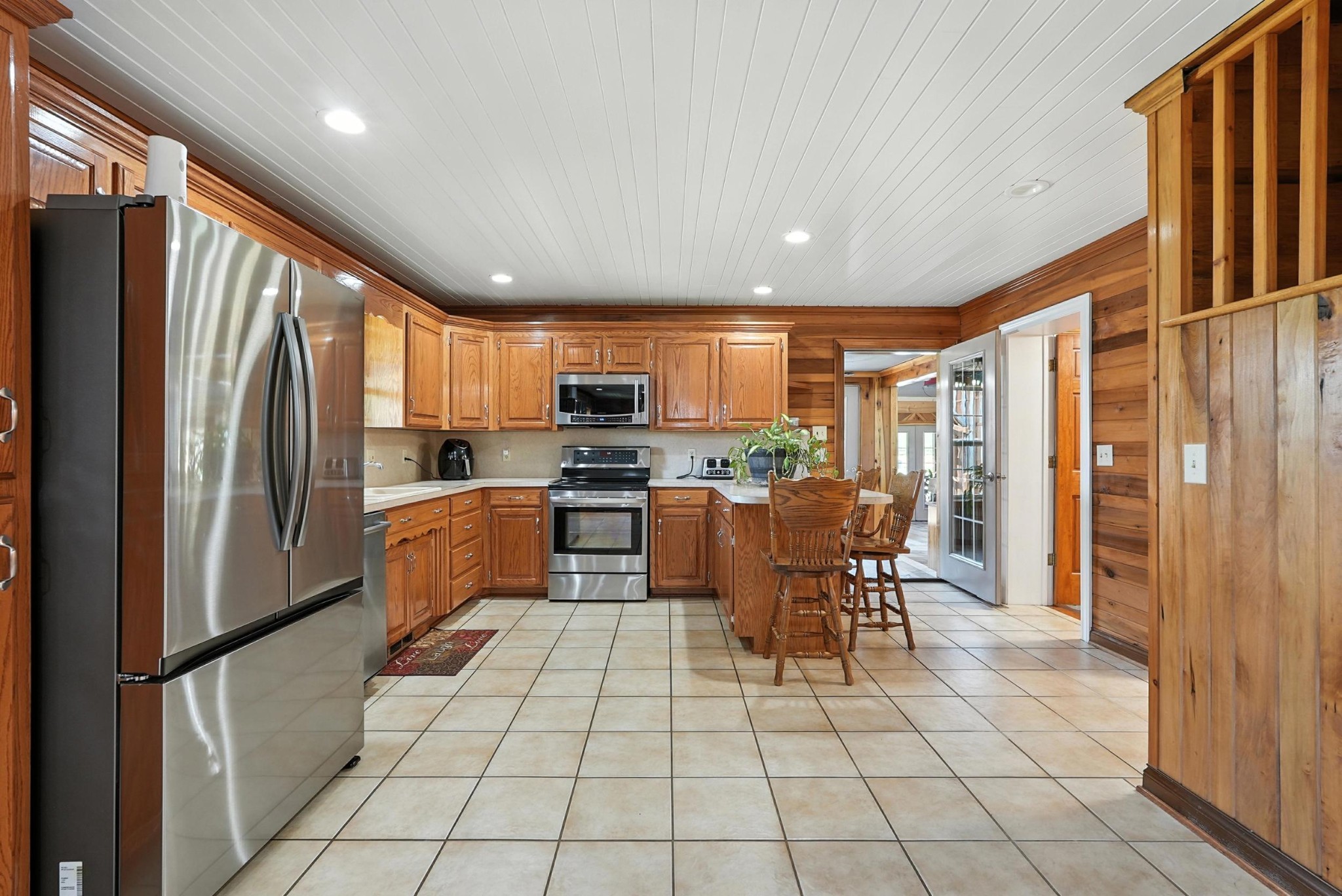 1880 Clydeton Road Waverly, TN 37185 - Photo 44 of 85 a kitchen with stainless steel appliances granite countertop a refrigerator a stove top oven and cabinets