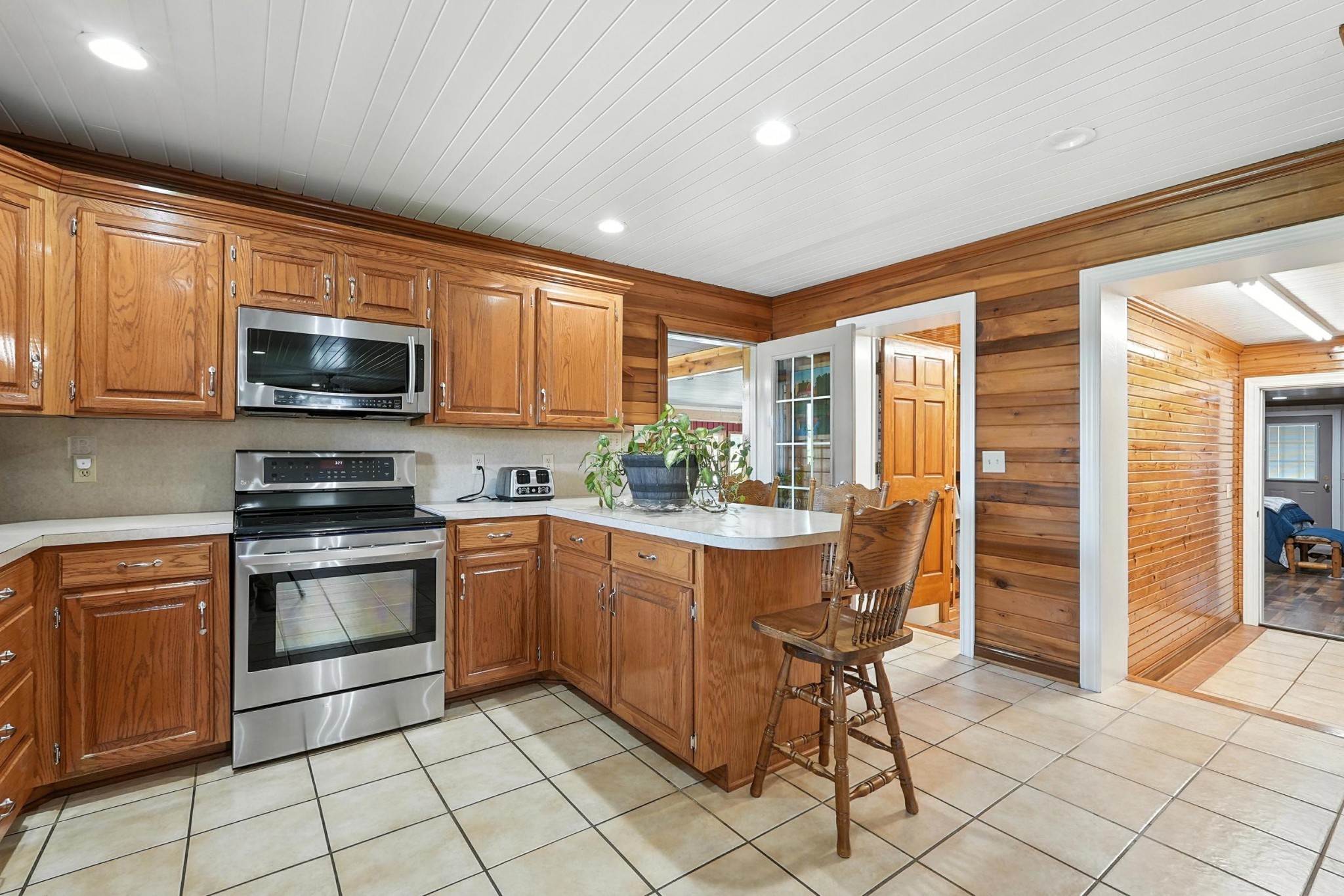1880 Clydeton Road Waverly, TN 37185 - Photo 45 of 85 a kitchen with stainless steel appliances granite countertop a stove a sink and a microwave