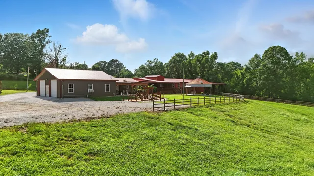 a view of a two room with wooden floor and iron stairs