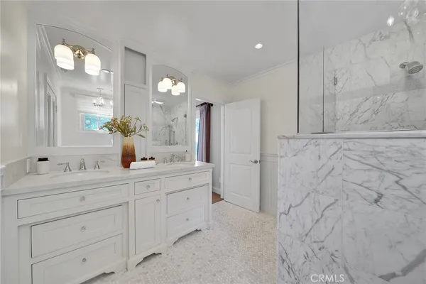 a bathroom with a double vanity sink mirror and
