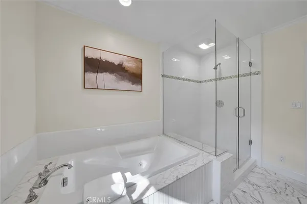 a bathroom with a bathtub and a shower