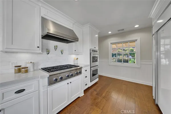 a kitchen with stainless steel appliances a stove a microwave and cabinets