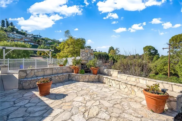 a view of a terrace with furniture and city view