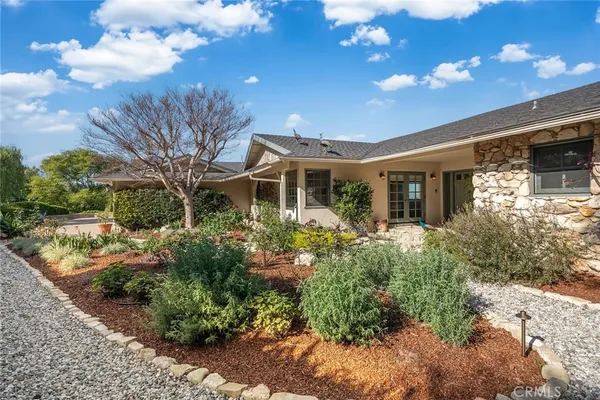 a front view of a house with garden