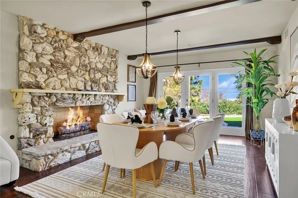 a dining room with furniture a chandelier and wooden floor