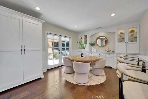 a living room with furniture a window and wooden floor