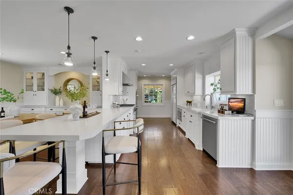 a large kitchen with granite countertop a large island in the center