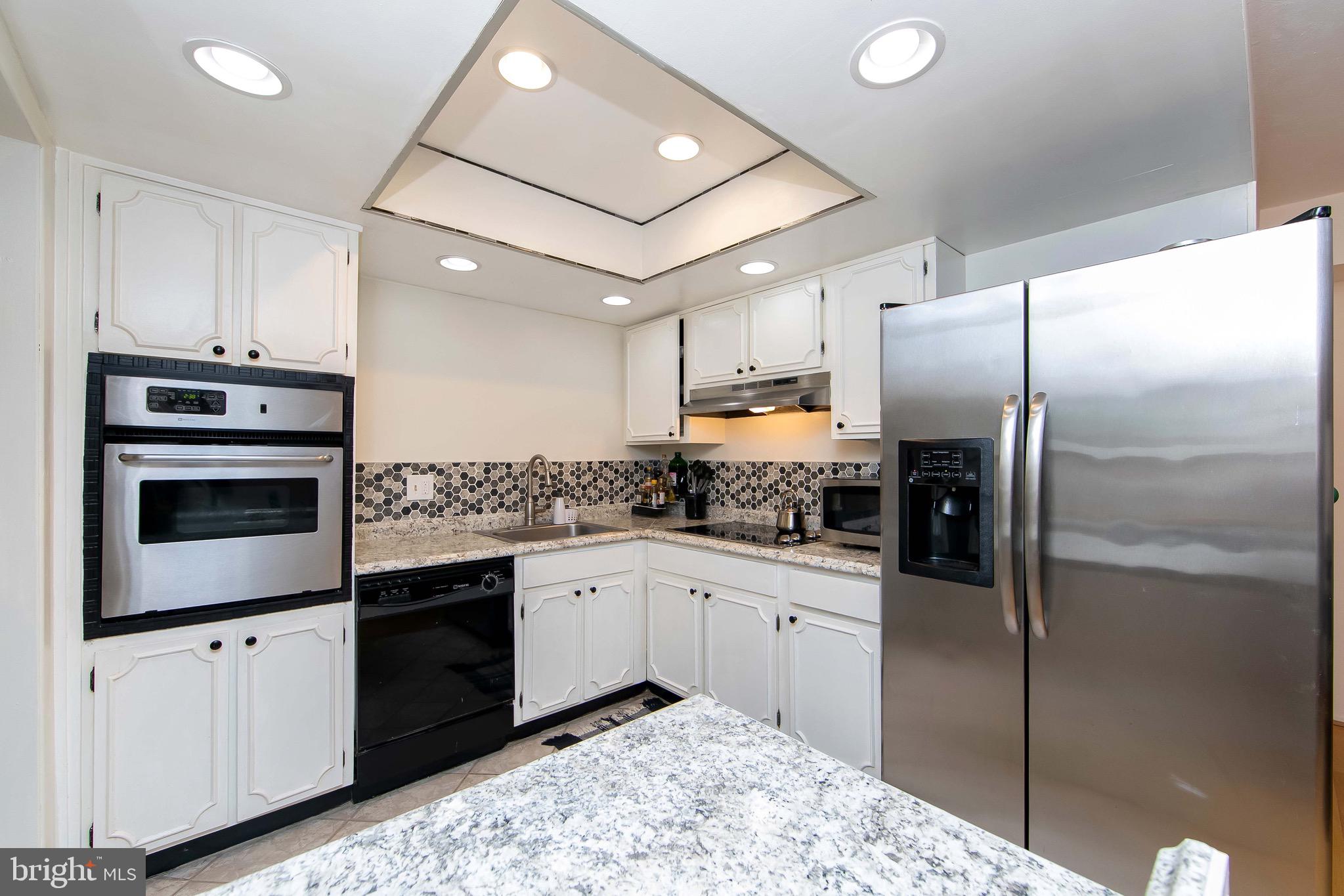 40 Rittenhouse Drive Willingboro, NJ 08046 - Photo 8 of 32 a kitchen with a sink stainless steel appliances and cabinets