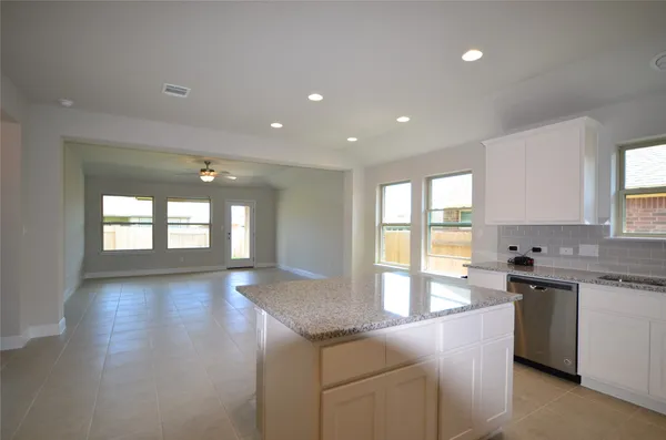 a large kitchen with stainless steel appliances granite countertop a sink and a stove