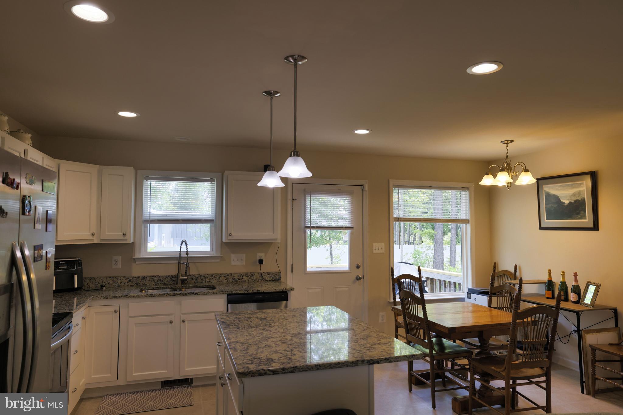 48 Rustic Lane Colonial Beach, VA 22443 - Photo 18 of 47 a kitchen with granite countertop a sink cabinets and window