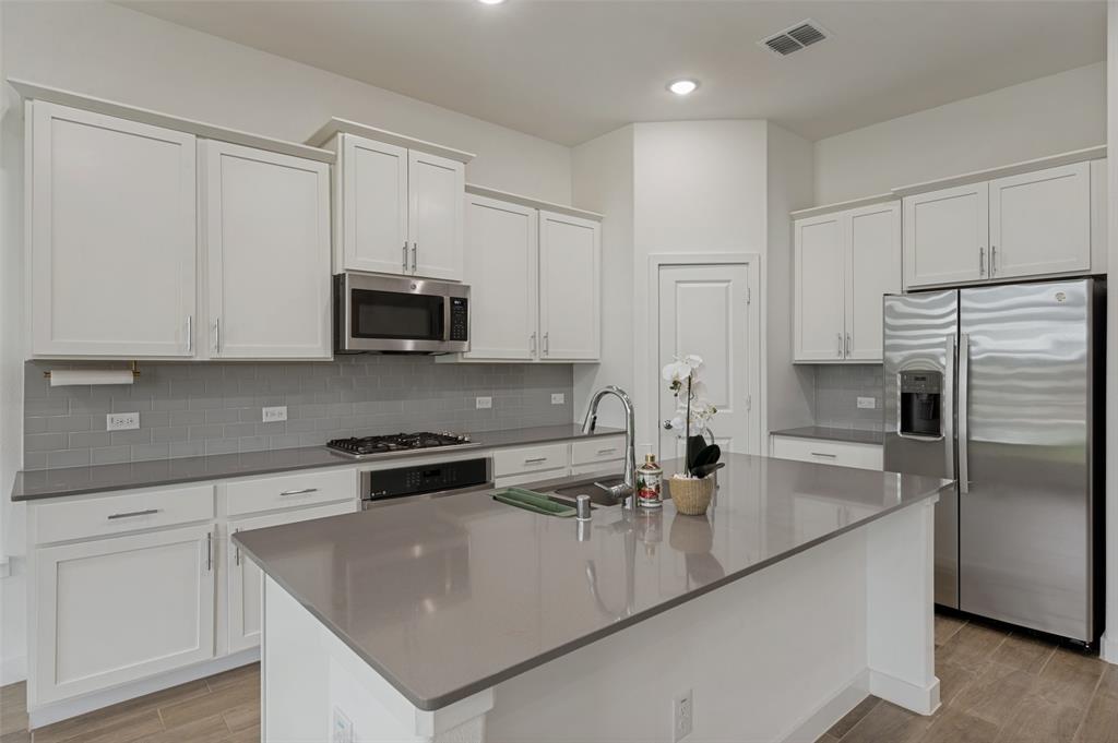 108 Invermore Drive Little Elm, TX 75068 - Photo 4 of 19 a kitchen with appliances a sink and cabinets
