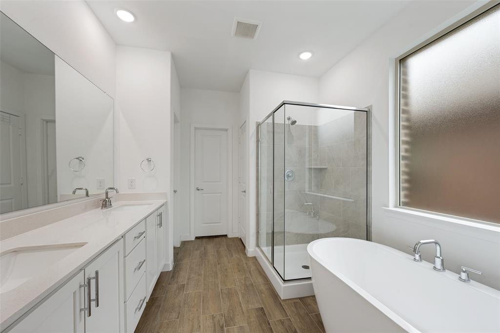 108 Invermore Drive Little Elm, TX 75068 - Photo 8 of 19 a bathroom with a double vanity sink a toilet and shower