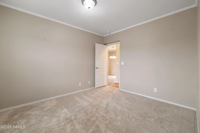 a view of a small space with wooden floor and a window