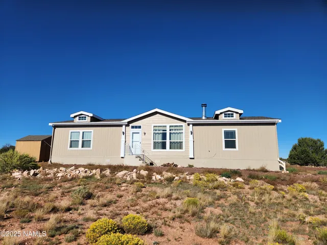 a view of a backyard with wooden fence