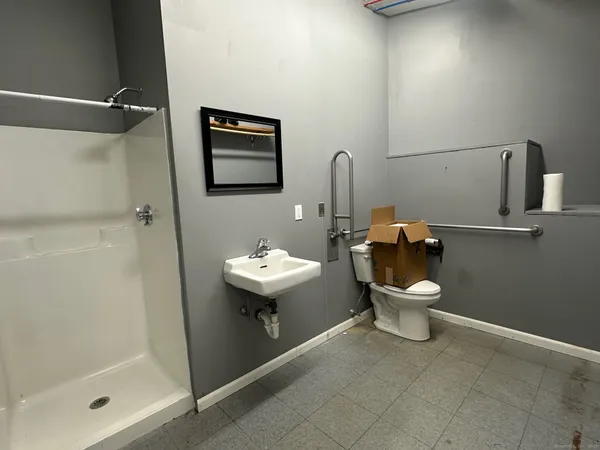 a white toilet sitting next to a bathroom sink