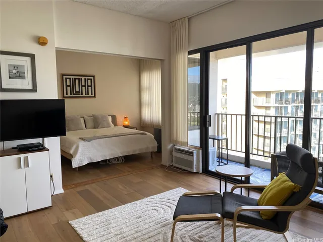 a bedroom with a bed a couch and a window