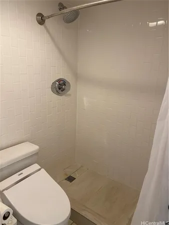 a bathroom with a toilet and a shower