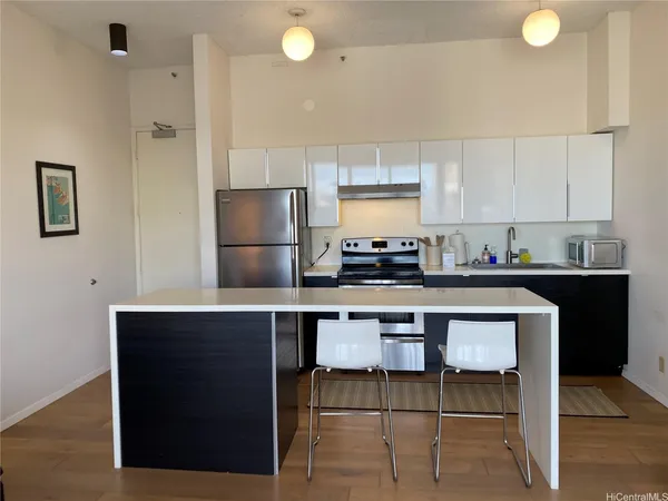 a kitchen with a sink cabinets and appliances
