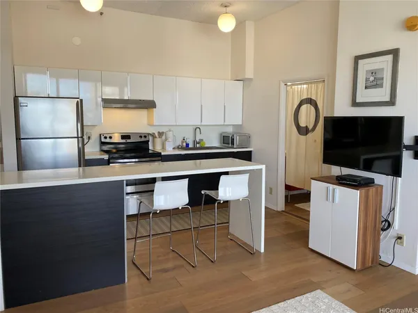 a kitchen with stainless steel appliances a stove a sink a microwave a refrigerator and cabinets