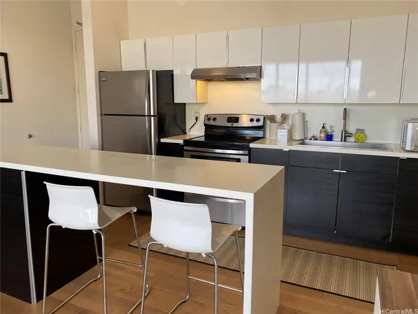 a kitchen with a stove a refrigerator and cabinets