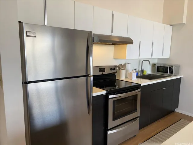 a kitchen with metallic refrigerator and stove