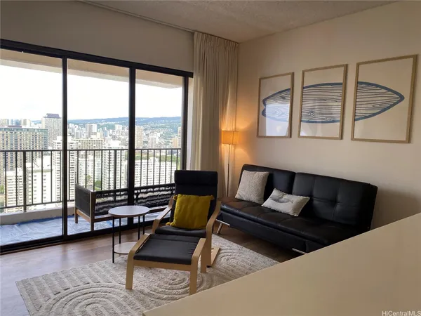 a living room with furniture and a floor to ceiling window