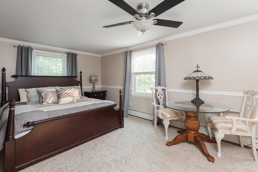324 Nye Road Barnstable, MA 02632 - Photo 14 of 37 a bedroom with a bed and a chandelier