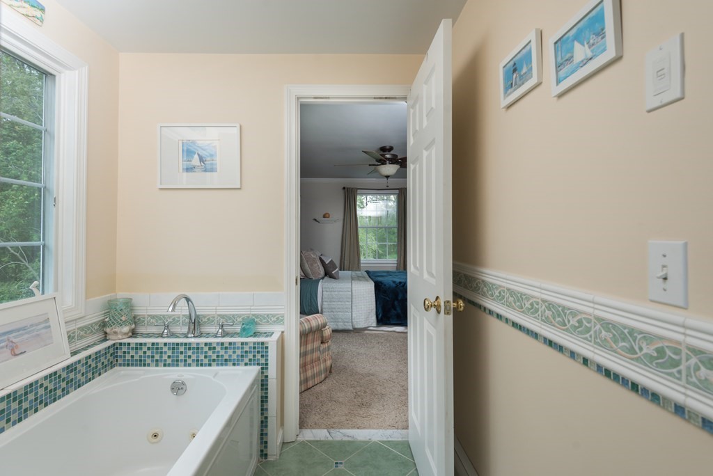 324 Nye Road Barnstable, MA 02632 - Photo 23 of 37 a bathroom with a granite countertop tub sink and mirror