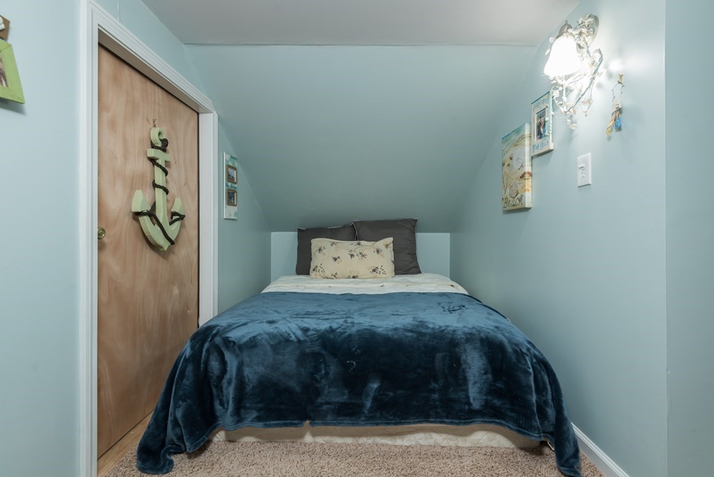 324 Nye Road Barnstable, MA 02632 - Photo 24 of 37 a bedroom with a bed and a chandelier