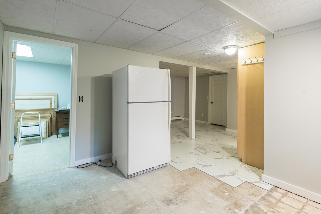 324 Nye Road Barnstable, MA 02632 - Photo 26 of 37 a view of a hallway with a refrigerator and a sink
