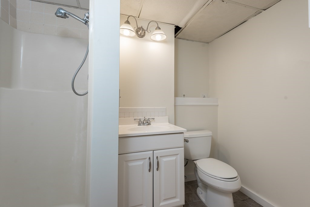 324 Nye Road Barnstable, MA 02632 - Photo 27 of 37 a bathroom with a granite countertop sink toilet and shower
