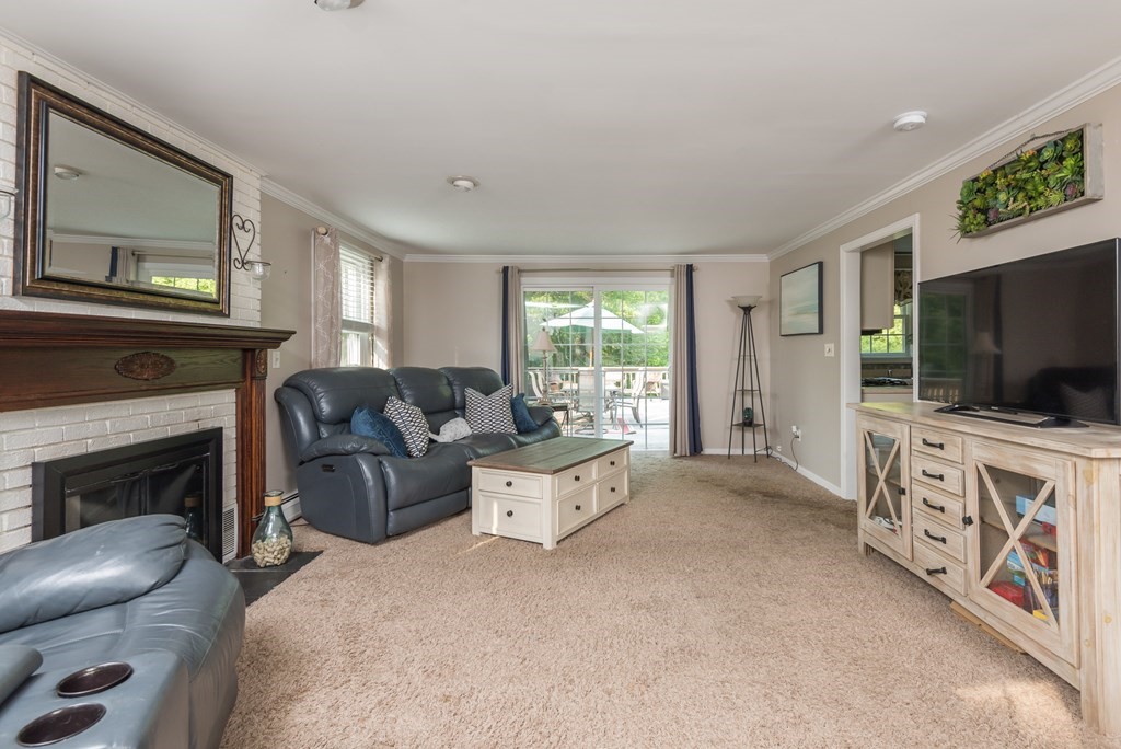 324 Nye Road Barnstable, MA 02632 - Photo 6 of 37 a living room with furniture a flat screen tv and a fireplace