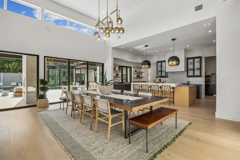a view of a dining room with furniture wooden floor and chandelier