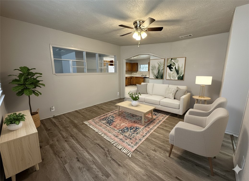 1302 East 23rd Street Bryan, TX 77803 - Photo 1 of 23 a living room with furniture a chandelier and a rug