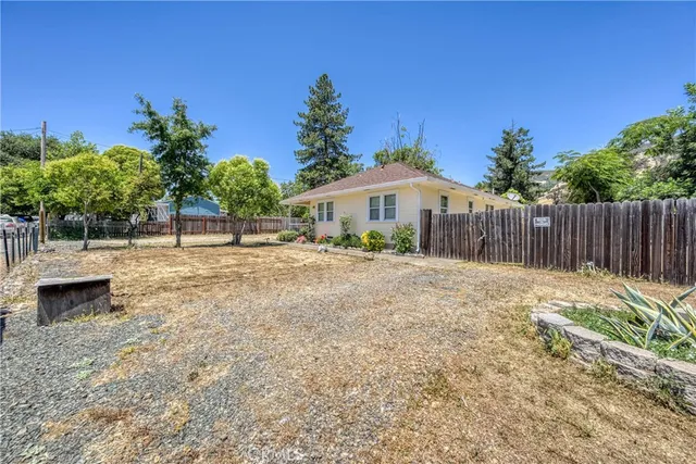 a front view of a house with a yard and table and chair