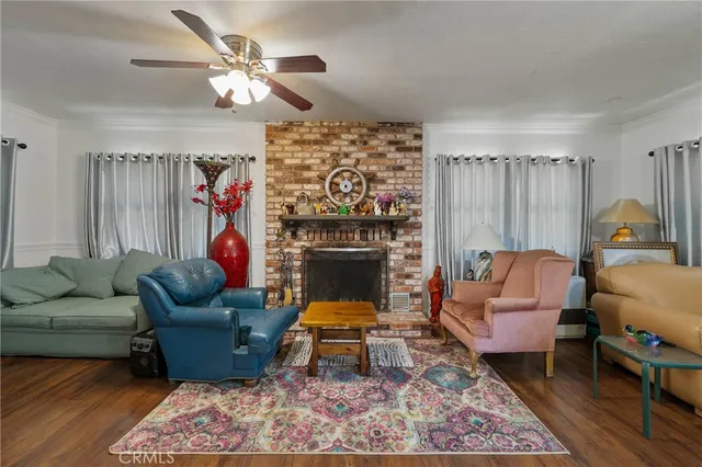 a living room with furniture a chandelier and a fireplace